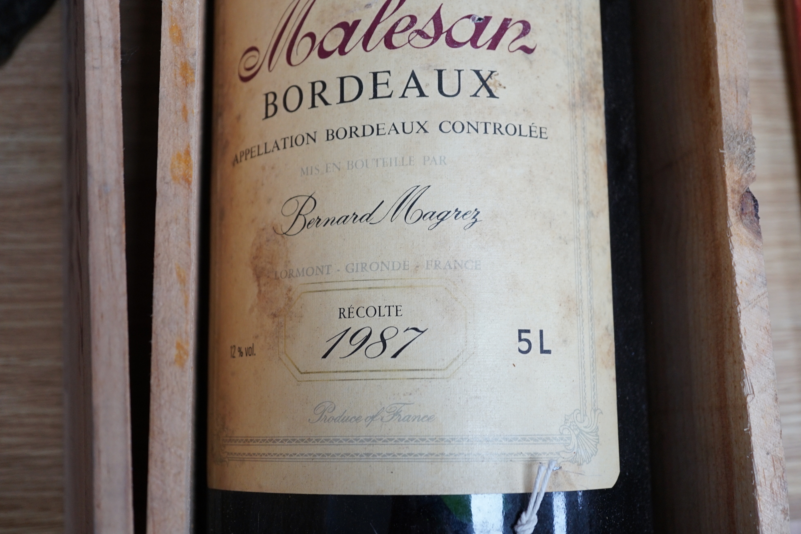 A 5 litre bottle of 1987 Malesan Bordeaux red wine in a wooden case, 50cm